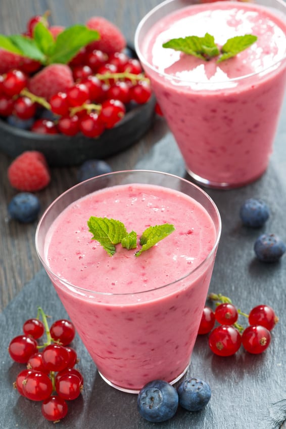 refreshing milkshake with fresh berries and mint in glass